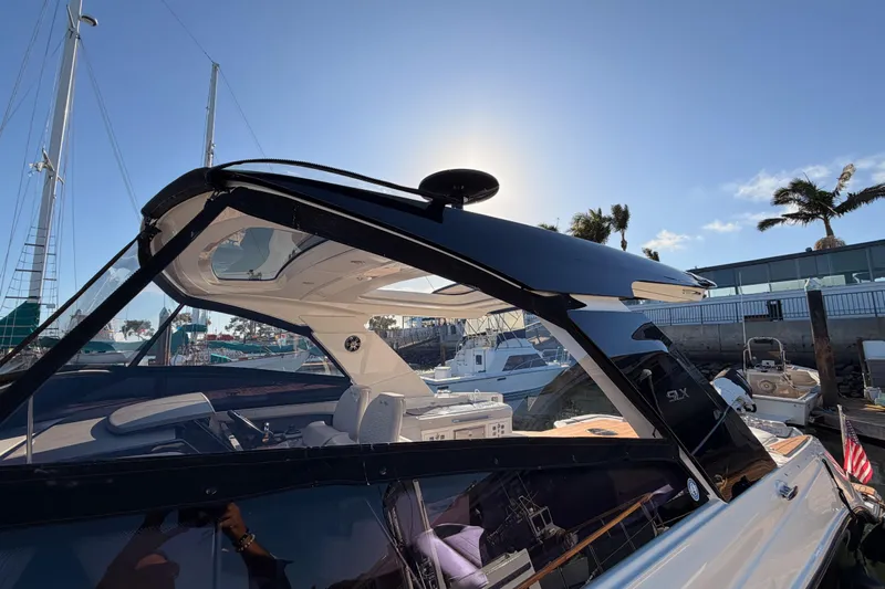  Yacht Photos Pics 2021 Sea Ray SLX 400 boat docked under clear blue sky.