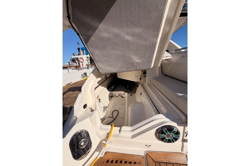  Yacht Photos Pics 2021 Sea Ray SLX 400 boat interior with open storage compartment and seating area.