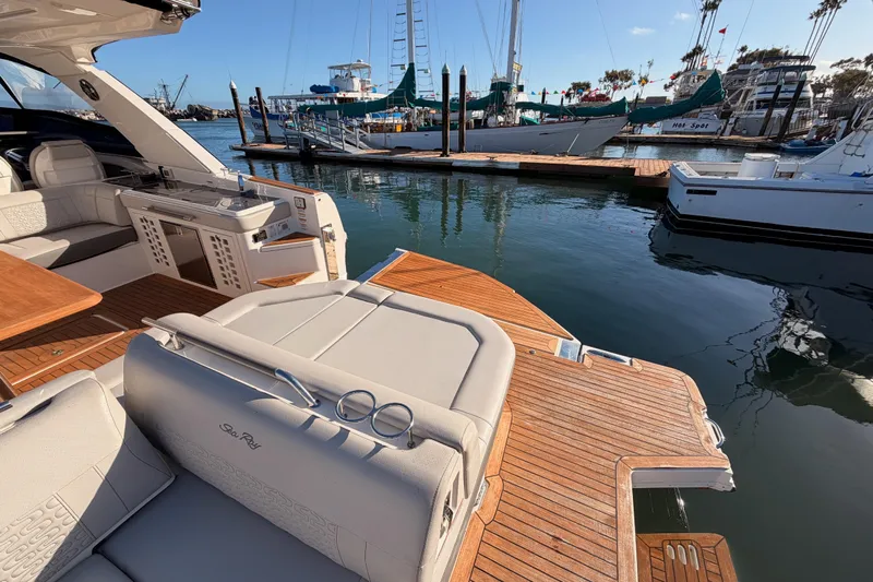 Yacht Photos Pics Luxurious 2021 Sea Ray SLX 400 yacht docked, showcasing elegant seating and teak deck.