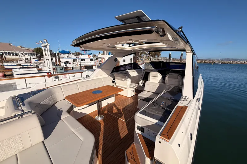  Yacht Photos Pics 2021 Sea Ray SLX 400 luxury boat with spacious seating and elegant design at a marina.