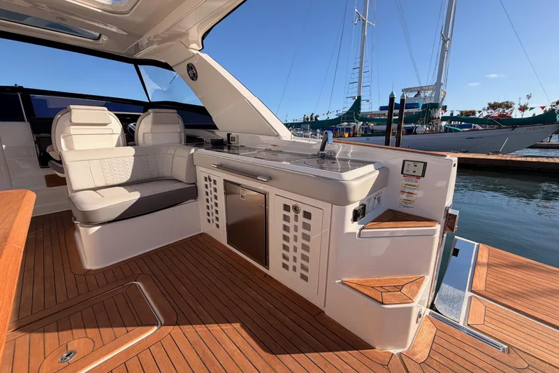  Yacht Photos Pics Luxurious 2021 Sea Ray SLX 400 yacht interior with seating and kitchenette, docked at marina.