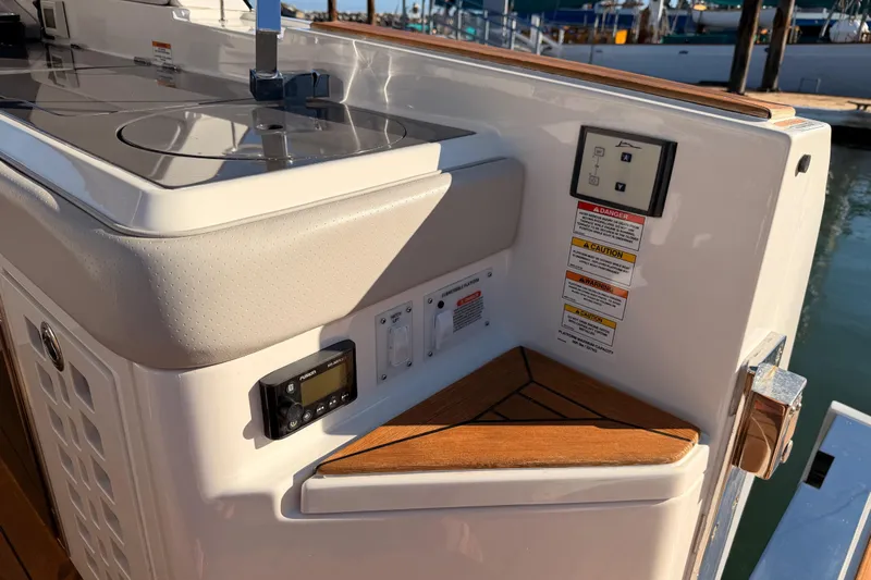  Yacht Photos Pics 2021 Sea Ray SLX 400 boat interior with control panel and wooden accents.