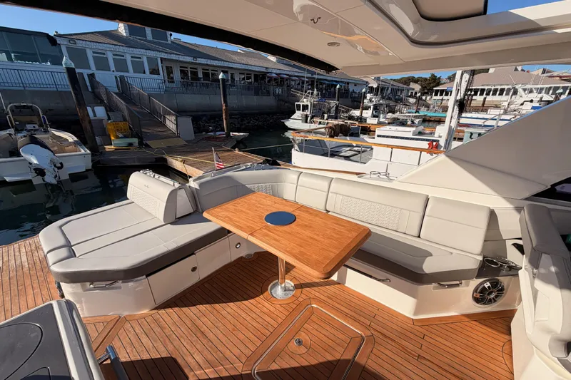  Yacht Photos Pics 2021 Sea Ray SLX 400 boat interior with elegant seating and wooden table at marina.