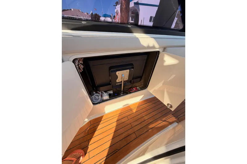  Yacht Photos Pics 2021 Sea Ray SLX 400 interior with open storage compartment and wooden flooring.