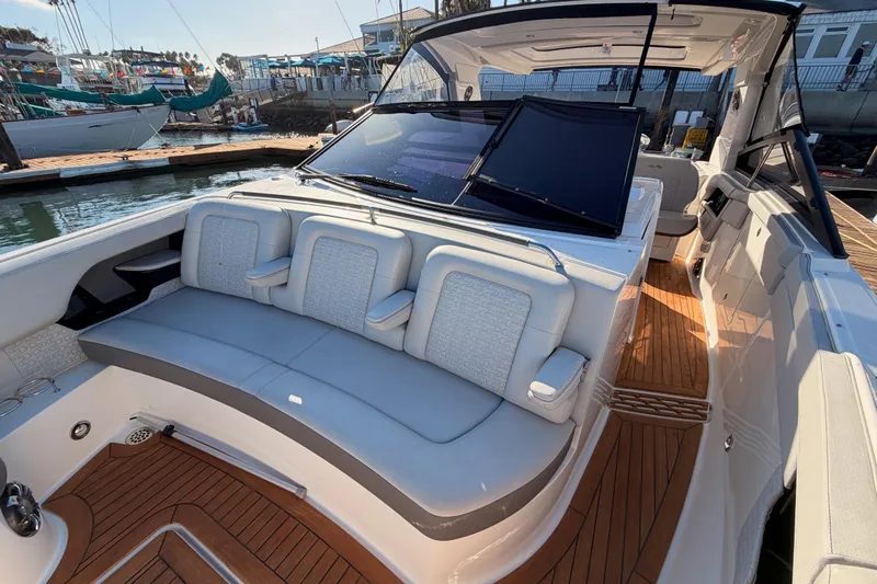  Yacht Photos Pics 2021 Sea Ray SLX 400 boat interior with luxurious seating and wooden deck.