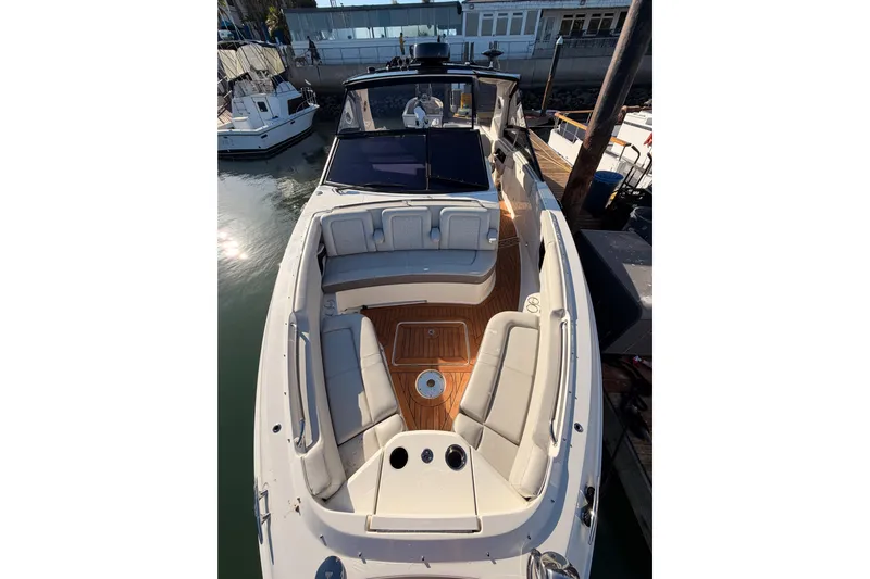  Yacht Photos Pics 2021 Sea Ray SLX 400 boat with spacious seating and elegant design at a marina.