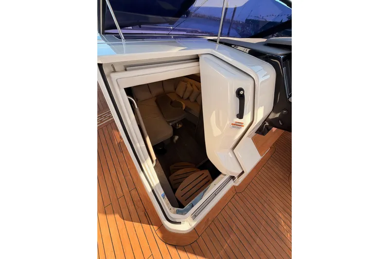  Yacht Photos Pics 2021 Sea Ray SLX 400 cabin entrance with teak flooring and cozy interior seating.