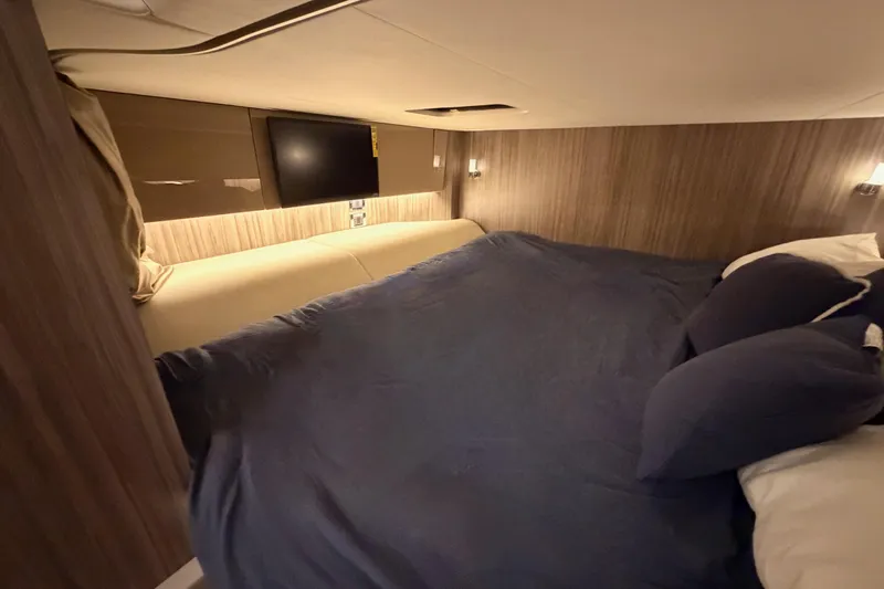  Yacht Photos Pics Luxurious cabin interior of 2021 Sea Ray SLX 400 with cozy bedding and ambient lighting.