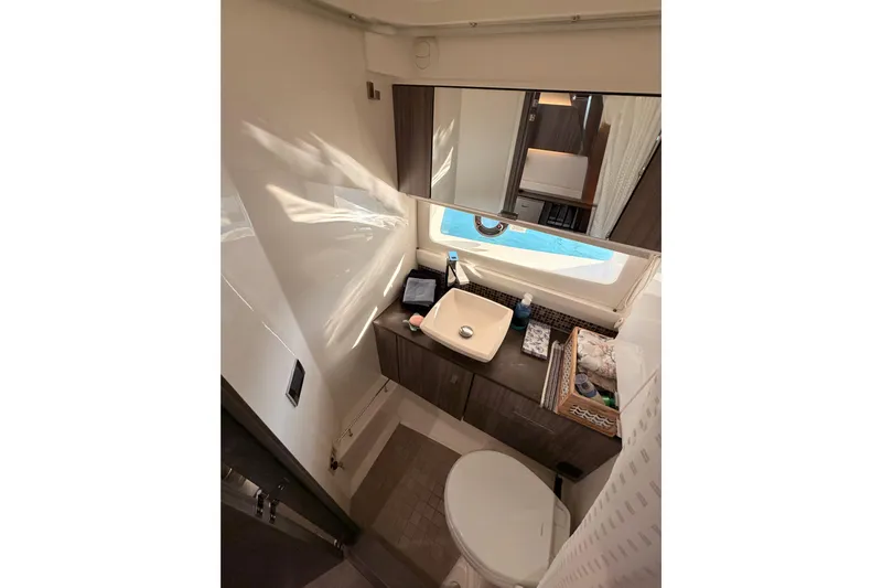 Yacht Photos Pics Luxurious bathroom in 2021 Sea Ray SLX 400 yacht with modern fixtures and window view.