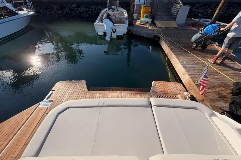  Yacht Photos Pics 2021 Sea Ray SLX 400 yacht docked, featuring spacious deck and American flag.