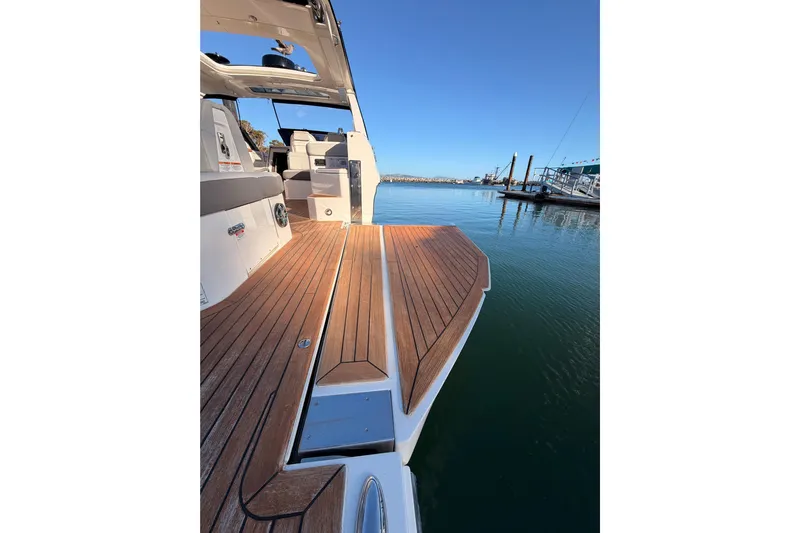  Yacht Photos Pics 2021 Sea Ray SLX 400 boat with teak deck, docked in a serene marina.