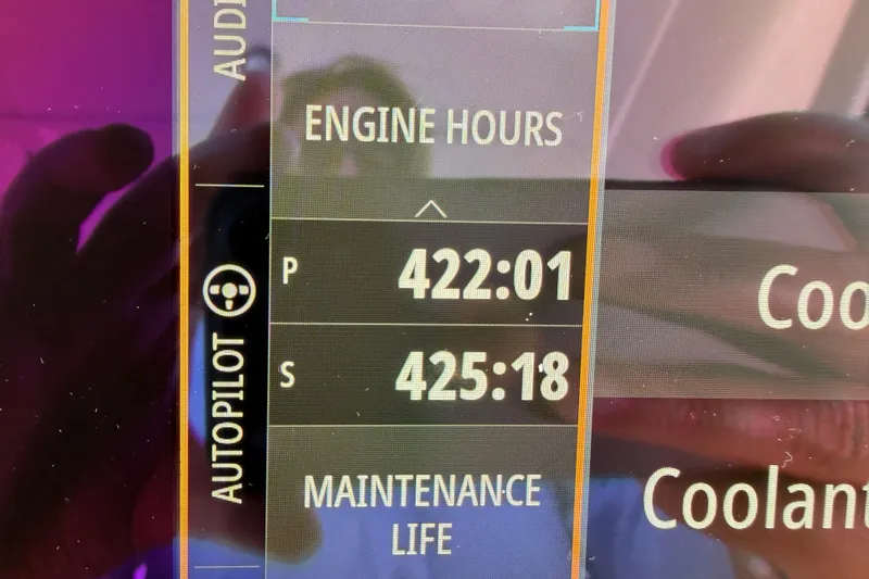 Yacht Photos Pics Dashboard display of a 2021 Sea Ray SLX 400 showing engine hours and maintenance life.