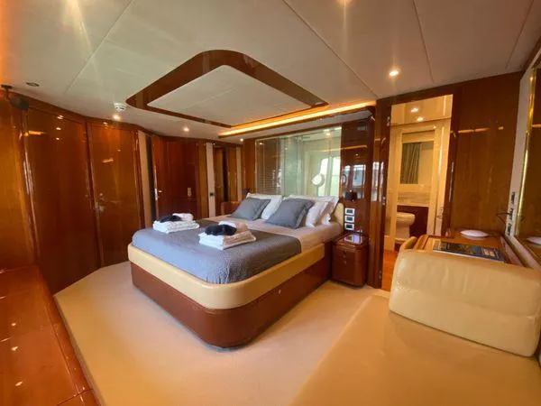 Lidia Yacht Photos Pics Luxurious bedroom interior of 2006 Ferretti Yachts 830, featuring elegant wood finishes and modern amenities.