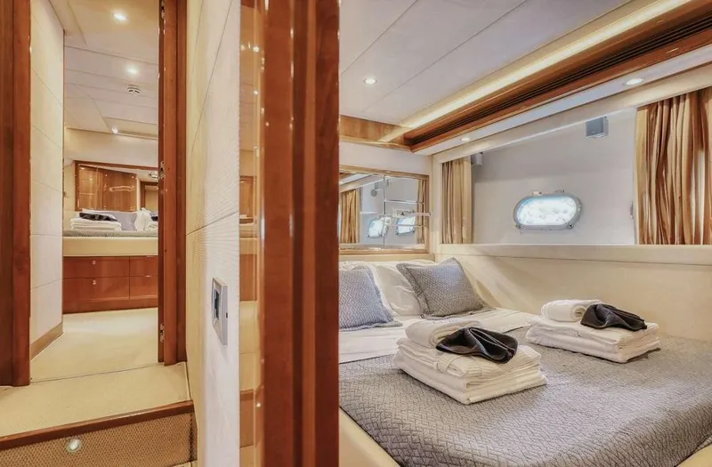 Lidia Yacht Photos Pics Luxurious bedroom interior of 2006 Ferretti Yachts 830, featuring elegant bedding and warm lighting.