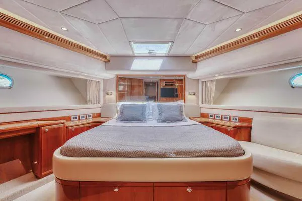Lidia Yacht Photos Pics Luxurious bedroom interior of 2006 Ferretti Yachts 830 with elegant wood finishes.