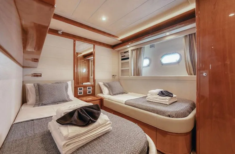 Lidia Yacht Photos Pics Luxurious twin cabin on 2006 Ferretti Yachts 830, featuring elegant bedding and wood finishes.