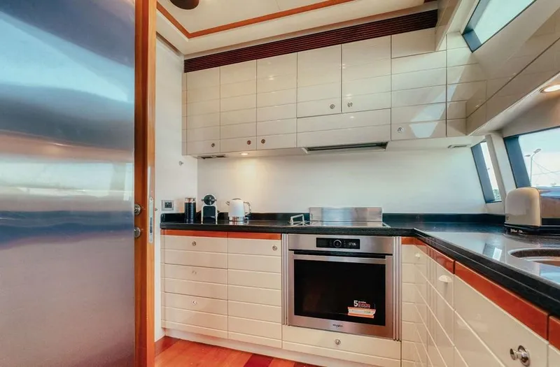 Lidia Yacht Photos Pics Luxurious kitchen interior of 2006 Ferretti Yachts 830 with modern appliances and sleek cabinetry.