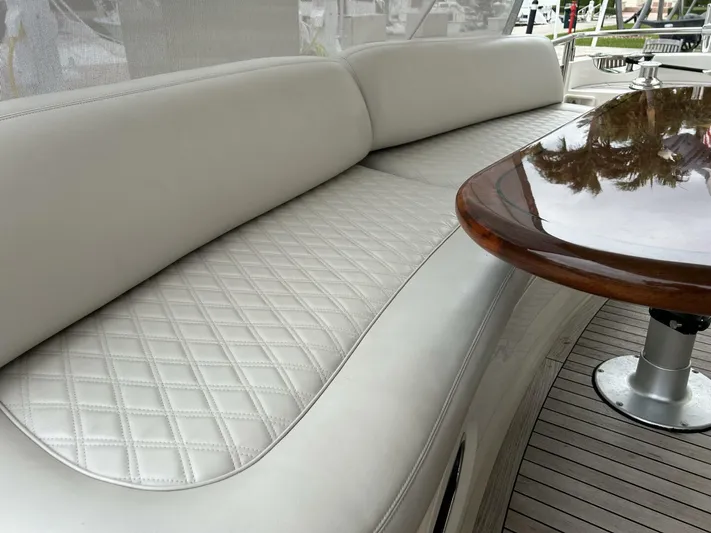 Uniq III Yacht Photos Pics Luxurious seating and table on 2008 Princess 67 Flybridge yacht.
