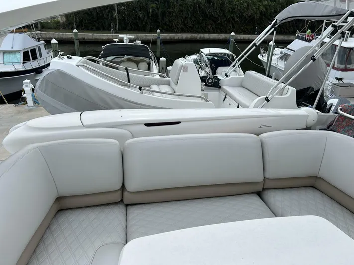 Uniq III Yacht Photos Pics 2008 Princess 67 Flybridge yacht with luxurious white seating at a marina.