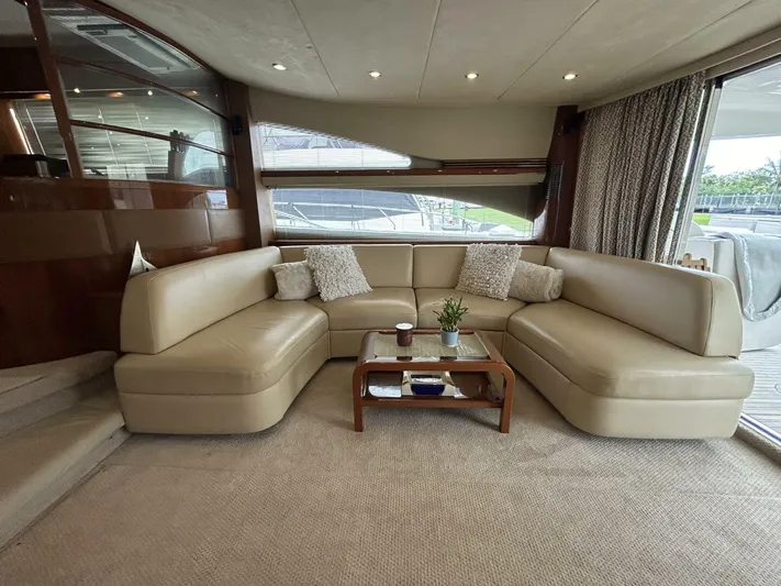 Uniq III Yacht Photos Pics Luxurious interior of 2008 Princess 67 Flybridge yacht with beige leather seating and elegant decor.