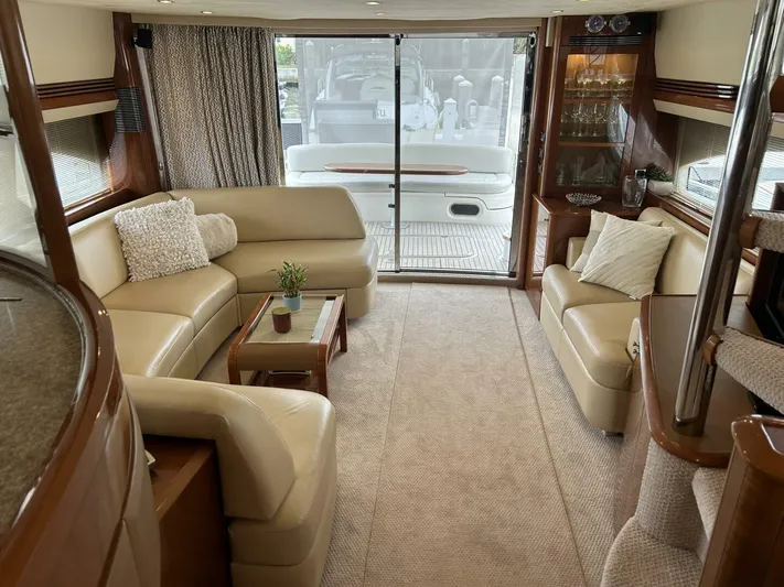 Uniq III Yacht Photos Pics Luxurious interior of 2008 Princess 67 Flybridge yacht with elegant seating and decor.