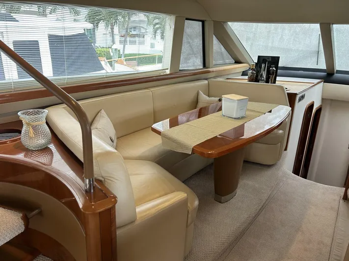 Uniq III Yacht Photos Pics Luxurious interior of 2008 Princess 67 Flybridge yacht with elegant seating and dining area.