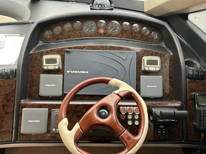 Uniq III Yacht Photos Pics Helm of 2008 Princess 67 Flybridge yacht with Furuno navigation system and Raymarine controls.