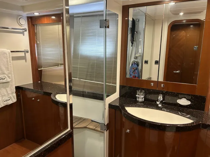 Uniq III Yacht Photos Pics Luxurious bathroom interior of 2008 Princess 67 Flybridge yacht with elegant wood and glass finishes.