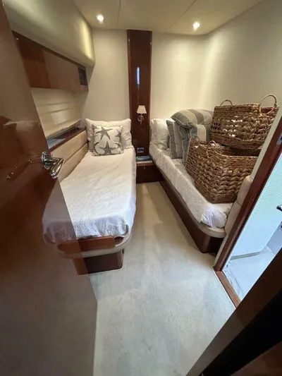 Uniq III Yacht Photos Pics 2008 Princess 67 Flybridge cabin with twin beds and wicker baskets.