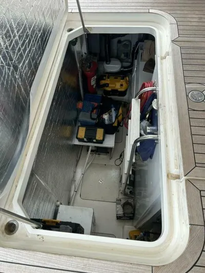 Uniq III Yacht Photos Pics Engine compartment of 2008 Princess 67 Flybridge yacht, showcasing equipment and storage.