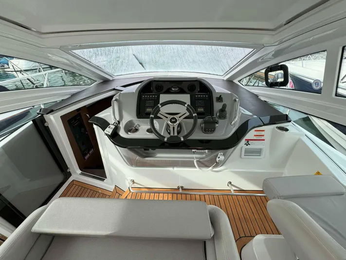 Heidibal 11 Yacht Photos Pics 2021 Beneteau Gran Turismo 40 helm station with modern controls and panoramic windows.