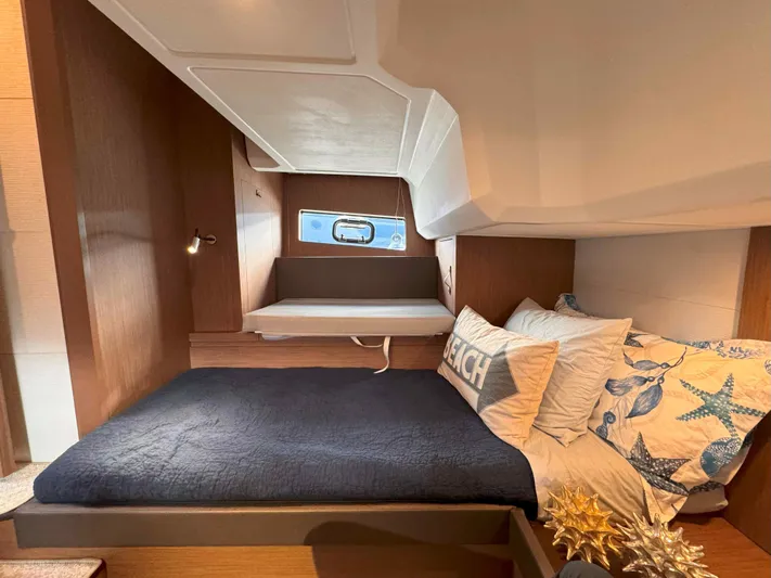 Heidibal 11 Yacht Photos Pics Interior cabin of 2021 Beneteau Gran Turismo 40 with cozy bedding and modern design.