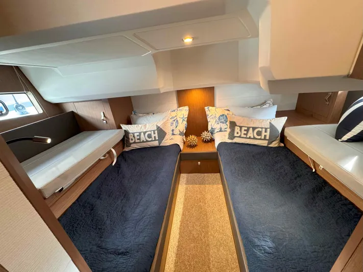 Heidibal 11 Yacht Photos Pics 2021 Beneteau Gran Turismo 40 cabin with twin beds and beach-themed decor.