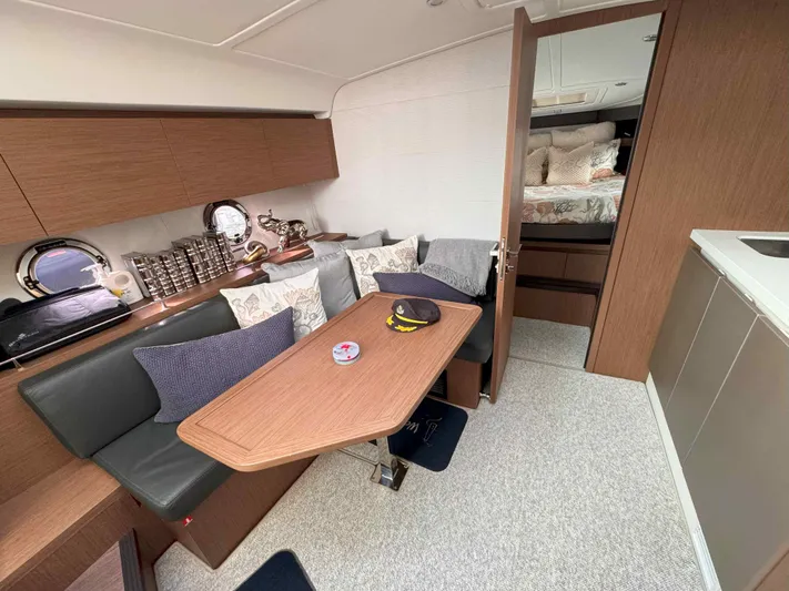 Heidibal 11 Yacht Photos Pics Interior of 2021 Beneteau Gran Turismo 40 yacht with cozy seating and wooden table.