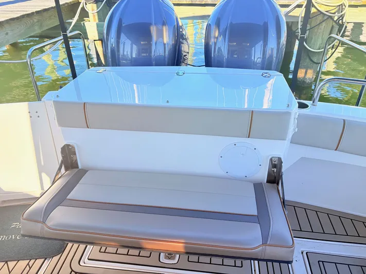Reliance Yacht Photos Pics Rear seating of 2023 Cutwater 32 Coupe with engines in background.