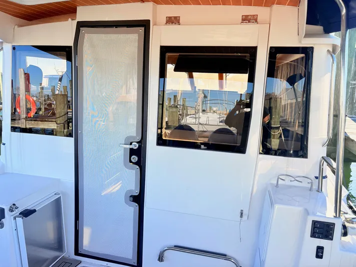 Reliance Yacht Photos Pics 2023 Cutwater 32 Coupe boat cabin with windows and door.