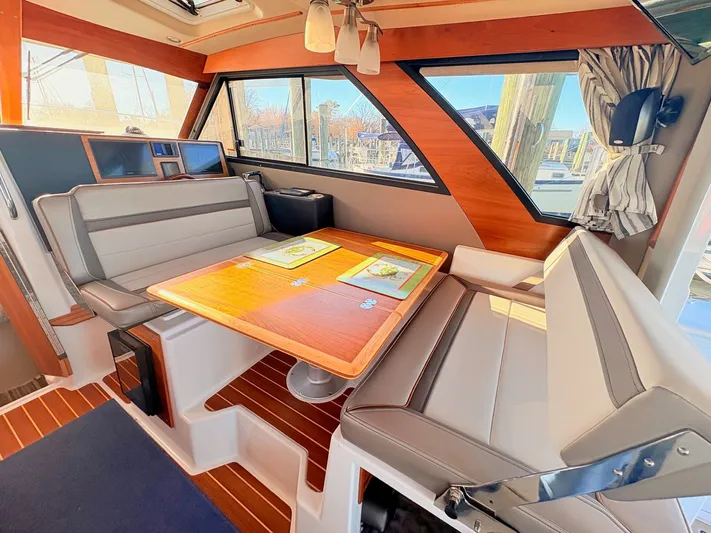 Reliance Yacht Photos Pics Interior of 2023 Cutwater 32 Coupe featuring elegant seating area.