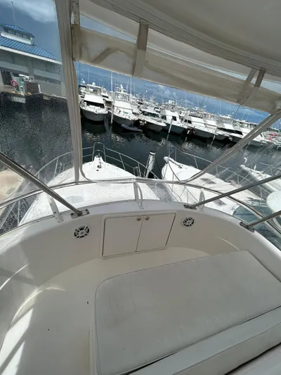  Yacht Photos Pics 2005 Riviera 37 Flybridge yacht docked at marina with clear view of surrounding boats.