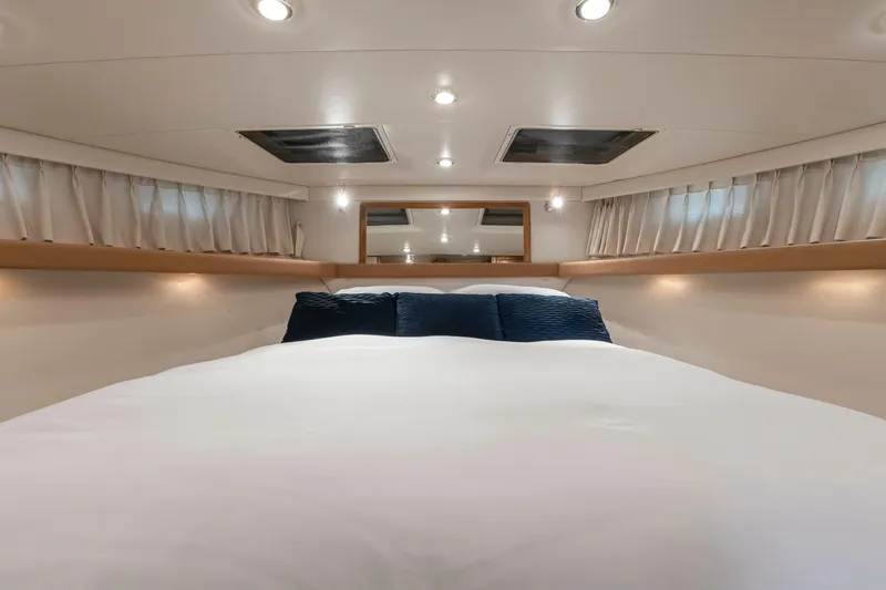 Never Say Never Yacht Photos Pics Luxurious bedroom interior of 1997 Bayliner 4788 Pilot House Motoryacht with elegant bedding.