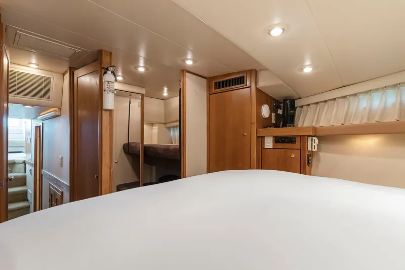 Never Say Never Yacht Photos Pics Interior of 1997 Bayliner 4788 Pilot House Motoryacht, featuring cozy cabin and wooden furnishings.