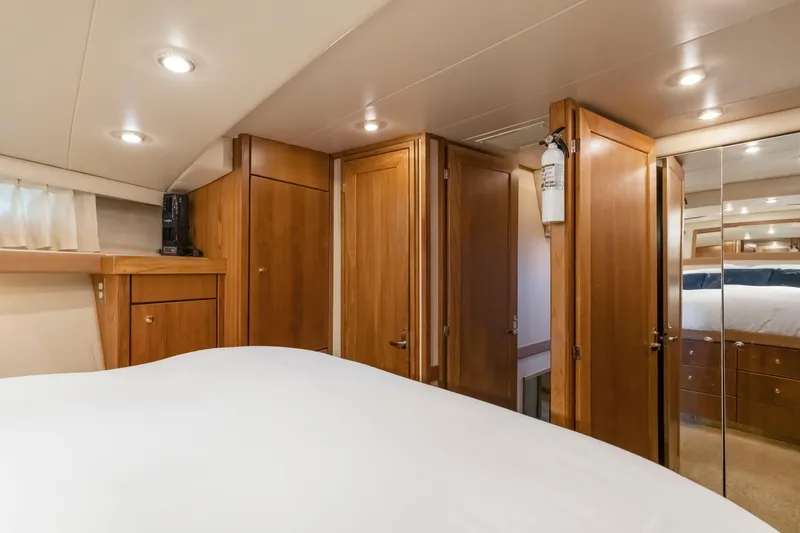 Never Say Never Yacht Photos Pics Interior of 1997 Bayliner 4788 Pilot House Motoryacht with wooden cabinetry and mirrored closet.