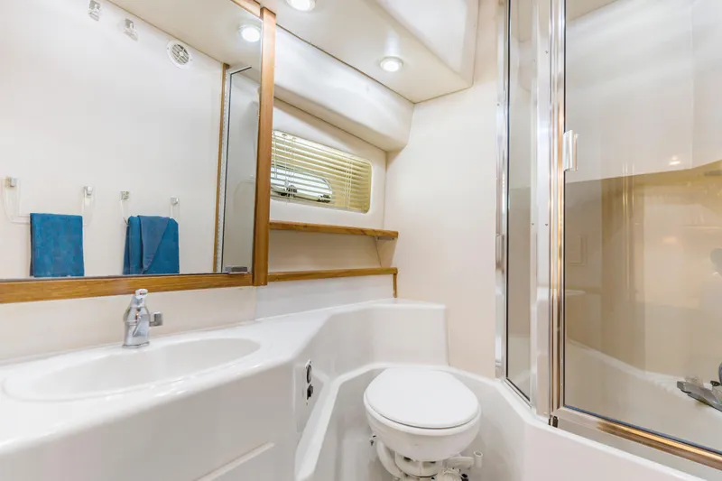 Never Say Never Yacht Photos Pics Bathroom interior of 1997 Bayliner 4788 Pilot House Motoryacht, featuring sink, toilet, and shower.