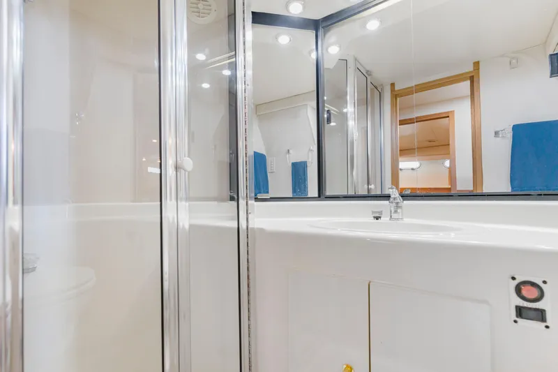 Never Say Never Yacht Photos Pics Bathroom interior of 1997 Bayliner 4788 Pilot House Motoryacht, featuring modern fixtures and mirrors.