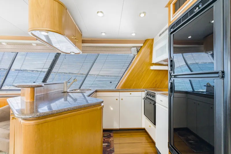 Never Say Never Yacht Photos Pics Luxurious kitchen interior of 1997 Bayliner 4788 Pilot House Motoryacht with modern appliances.