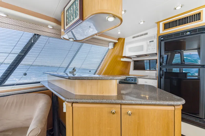 Never Say Never Yacht Photos Pics Luxurious 1997 Bayliner 4788 Pilot House Motoryacht interior with modern kitchen amenities.