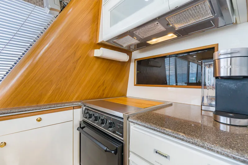 Never Say Never Yacht Photos Pics 1997 Bayliner 4788 Pilot House Motoryacht kitchen with stove, microwave, and coffee maker.