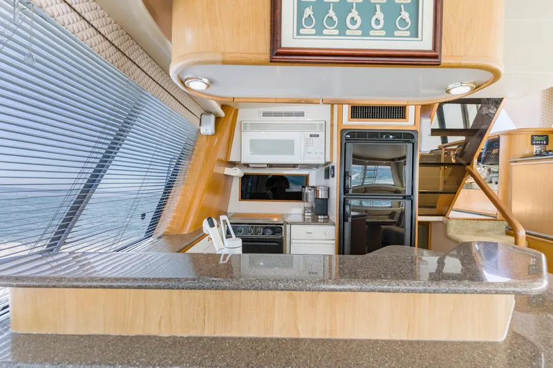 Never Say Never Yacht Photos Pics Luxurious kitchen interior of 1997 Bayliner 4788 Pilot House Motoryacht with modern appliances.