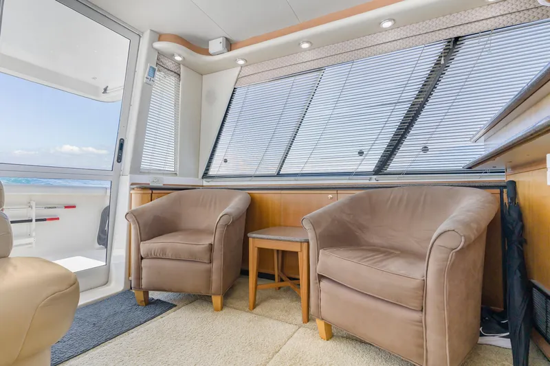 Never Say Never Yacht Photos Pics Interior of 1997 Bayliner 4788 Pilot House Motoryacht with cozy seating and large windows.