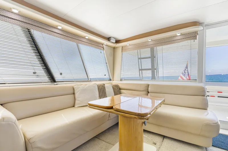 Never Say Never Yacht Photos Pics Luxurious interior of 1997 Bayliner 4788 Pilot House Motoryacht with plush seating and ocean view.