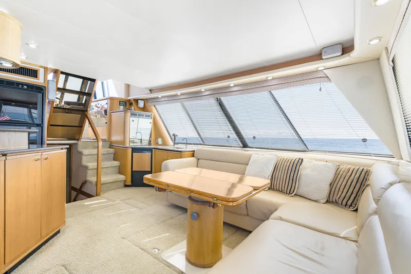 Never Say Never Yacht Photos Pics Luxurious interior of 1997 Bayliner 4788 Pilot House Motoryacht with plush seating and elegant design.